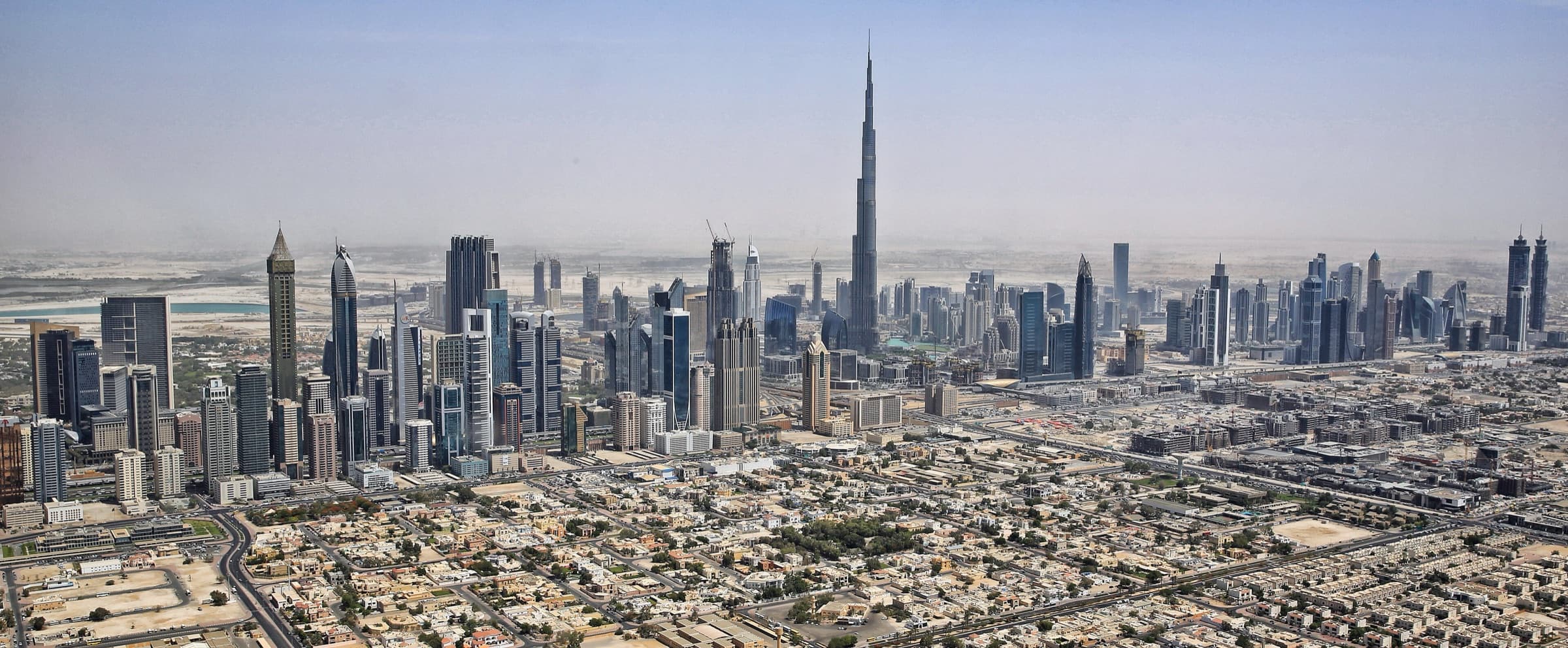 Aerial view of Downtown Dubai with the Burj Khalifa rising above the Sheikh Zayed Road towers
